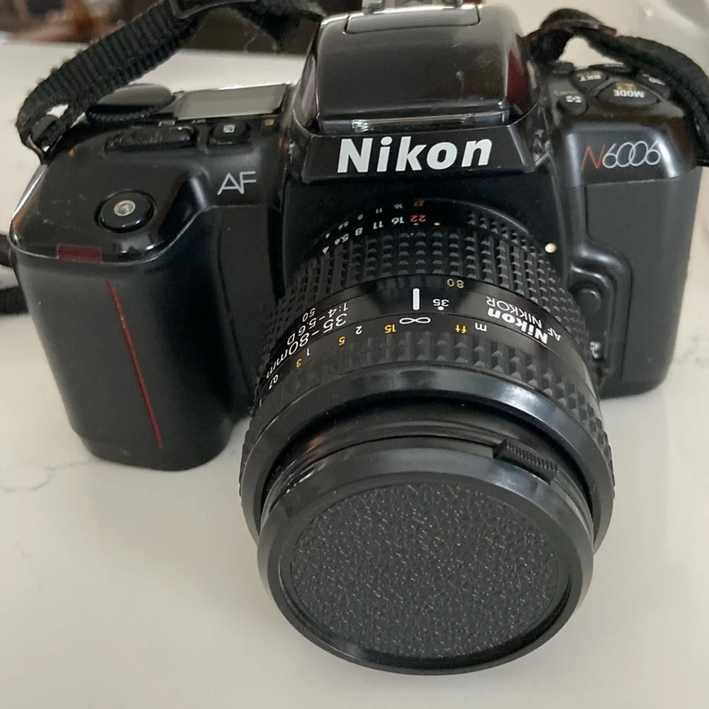 Nikon N6006 AF camera with lenses and leather bag.